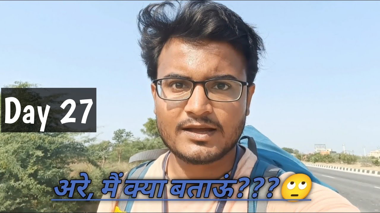 A man walking through the vibrant, arid landscape of Rajasthan, with traditional Indian architecture visible in the background. The scene captures the essence of a solo traveler's journey across India.