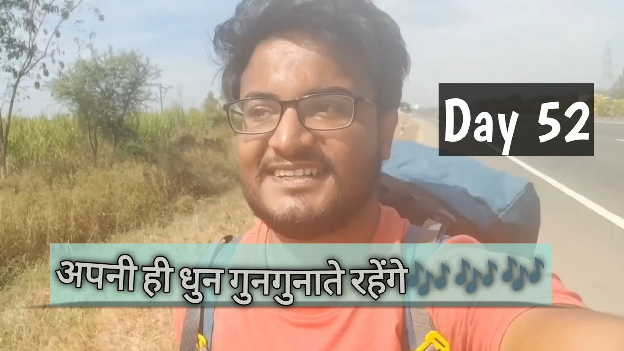 Pradeep Bhatt walks along a rural road from Tuljapur to Solapur, surrounded by the lush greenery and open landscapes of Maharashtra, bathed in sunlight.